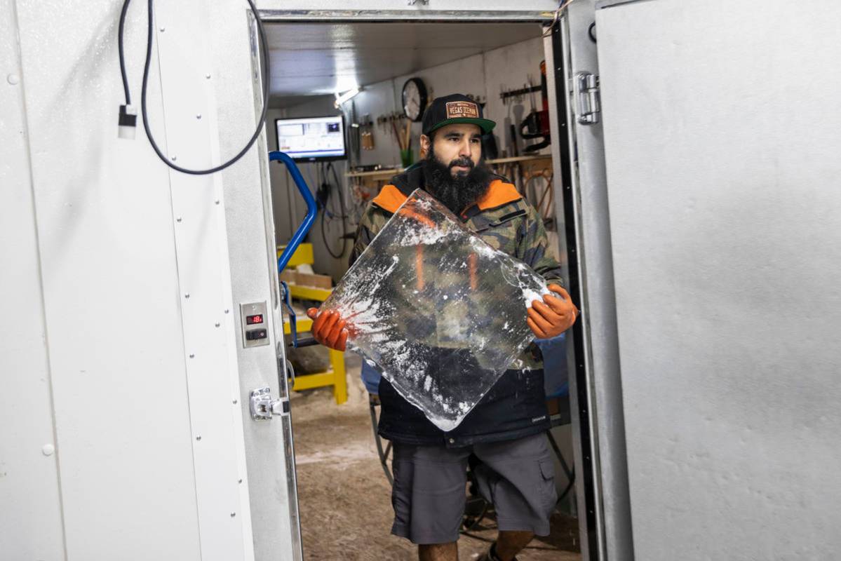 Marco Villarreal, known as "Vegas Ice Man," carries a fresh block of ice into his scu ...