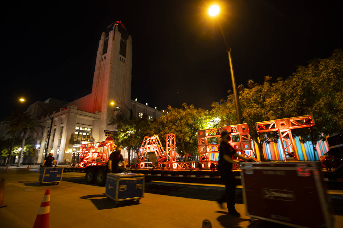 Entertainment workers push road cases past a "Red Alert" sign as The Smith Center tur ...