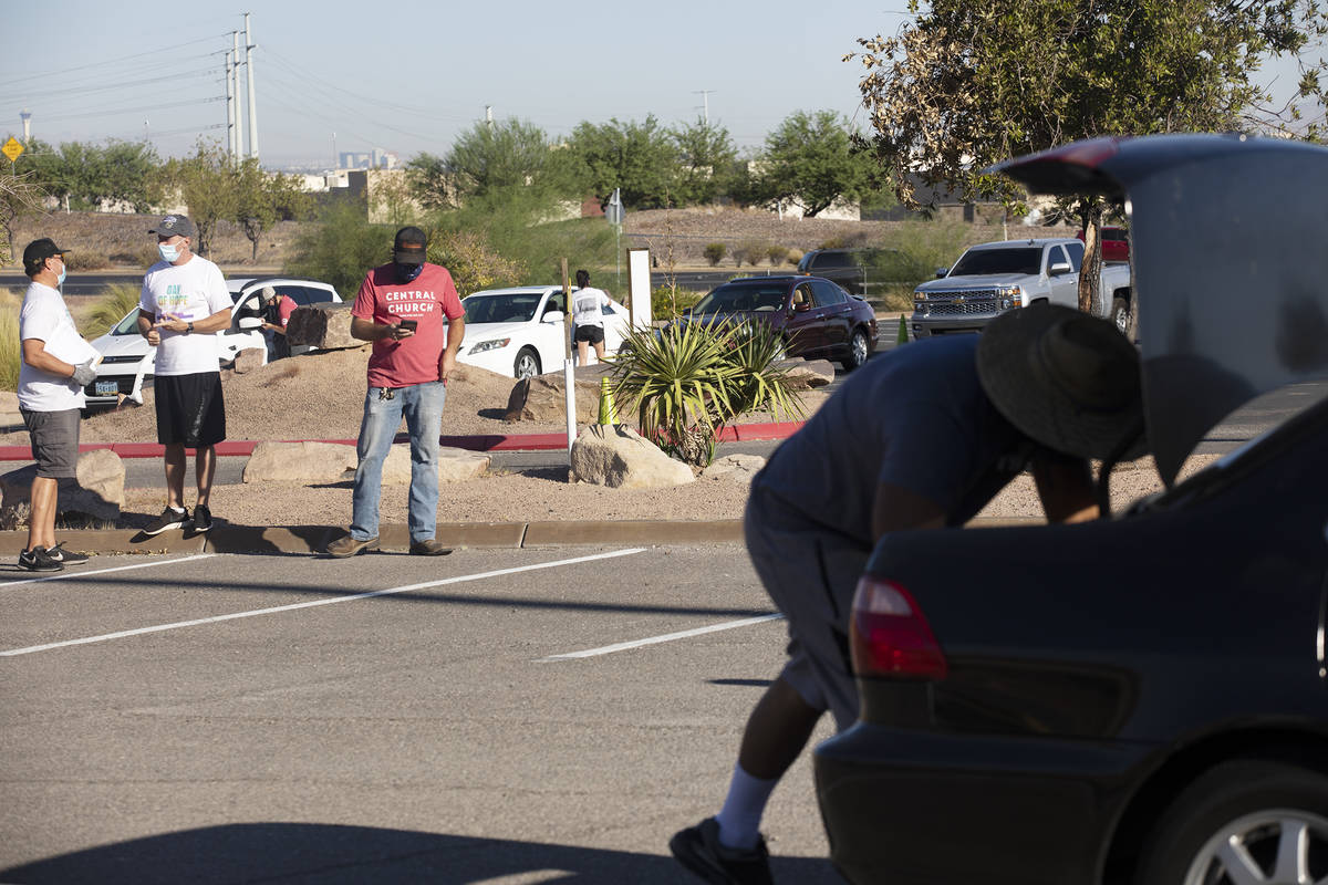 People line up at the new drive-thru distribution site for Three Square, Southern Nevada's larg ...