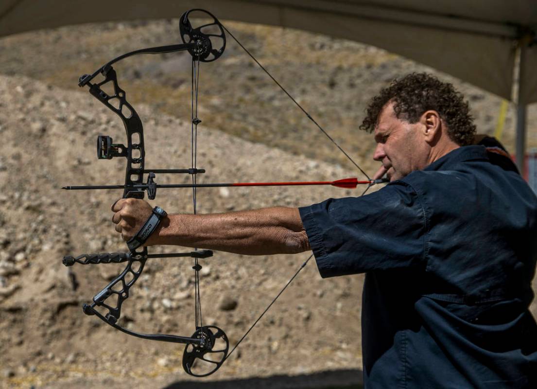 Adrenaline Mountain owner and CEO Eric Brashear eyes a target while using a compound bow, Thurs ...