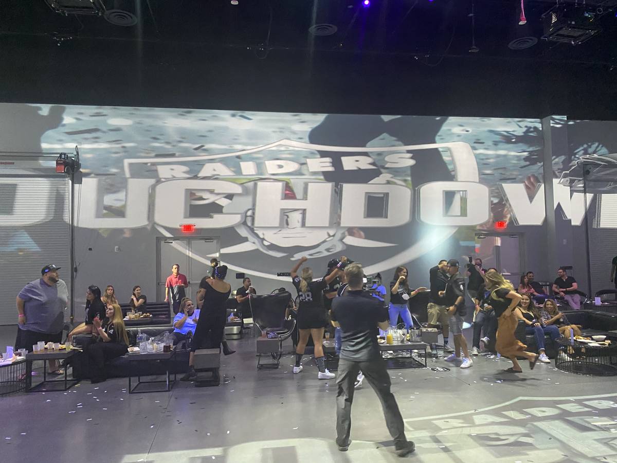 Las Vegas Raiders fans celebrate the team's first touchdown during the Portal at Area15's Raide ...