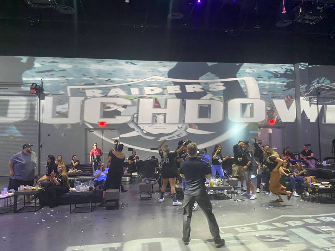 Las Vegas Raiders fans celebrate the team's first touchdown during the Portal at Area15's Raide ...
