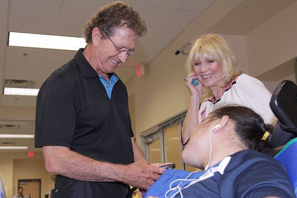 Mac Davis and Opportunity Village fonder Linda Smith are shown with an O.V. client at the organ ...