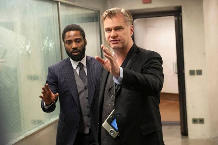John David Washington, left, and director/writer/producer Christopher Nolan on the set of Warne ...