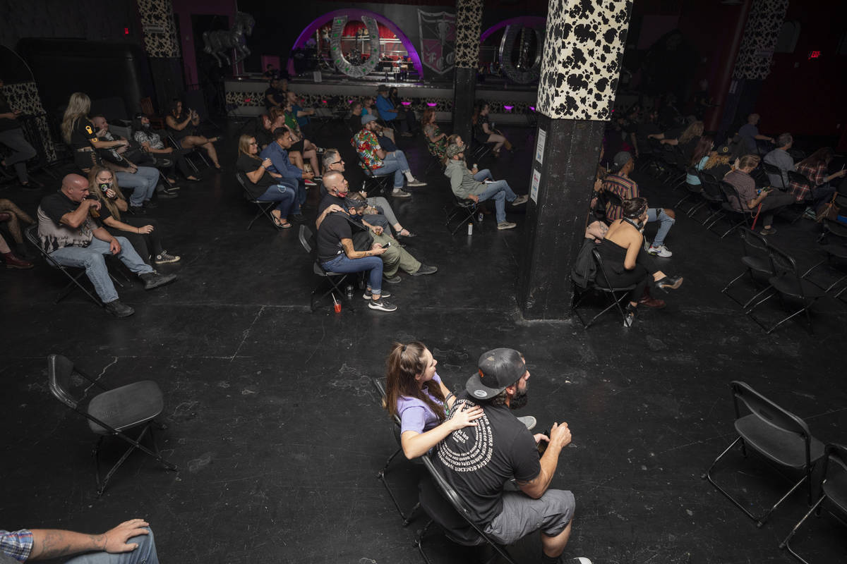 Concert goers sit socially distanced while listening to Shanda & the Howlers preform at the ...