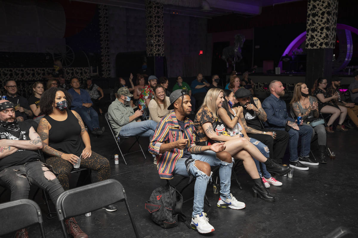 Concert goers sit socially distanced while listening to Shanda & the Howlers preform at the ...