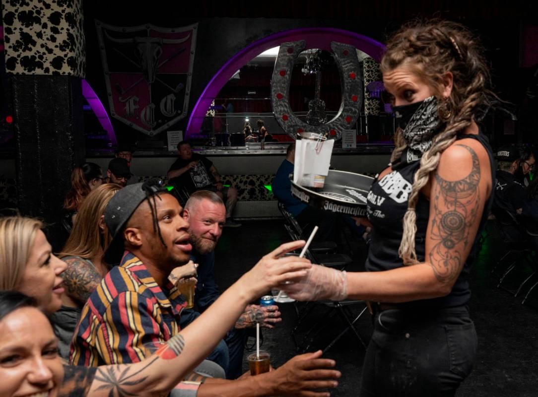 Bar tender Arinetta McGarvey delivers drinks to concert goers in their seats during Shanda &amp ...