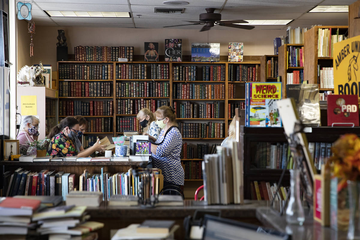 Customers shop for books at Amber Unicorn Books in Las Vegas, Wednesday, Oct. 21, 2020. The sto ...