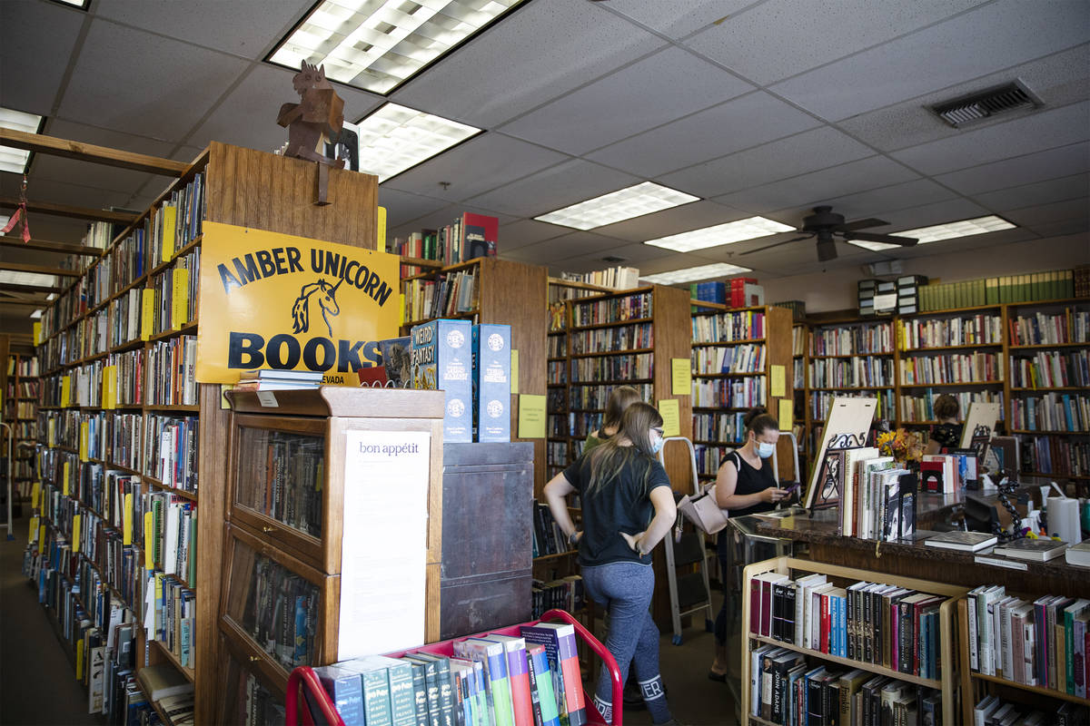Customers shop for books at Amber Unicorn Books in Las Vegas, Wednesday, Oct. 21, 2020. The sto ...