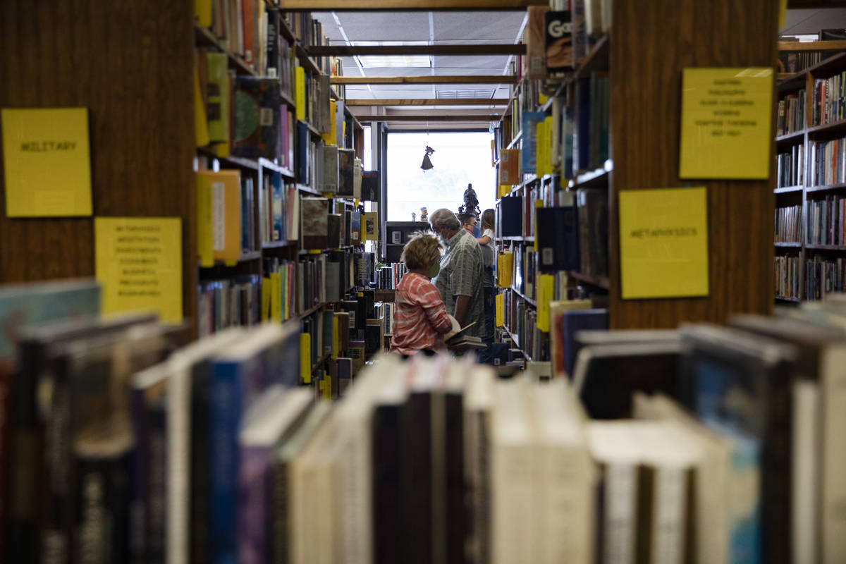 Customers shop for books at Amber Unicorn Books in Las Vegas, Wednesday, Oct. 21, 2020. The sto ...