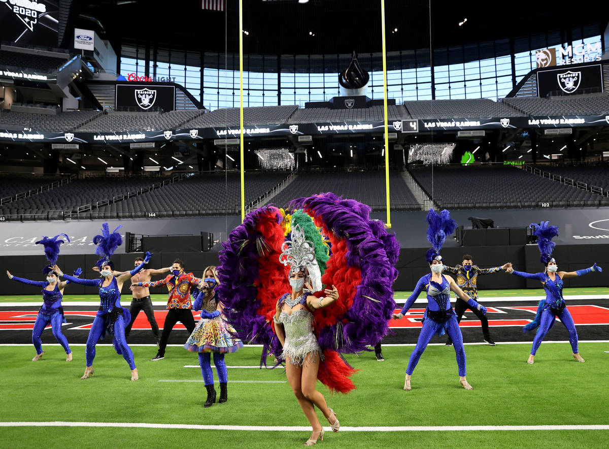 Las Vegas performers, including Nicole Pegado, front, put on a show at Allegiant Stadium as par ...