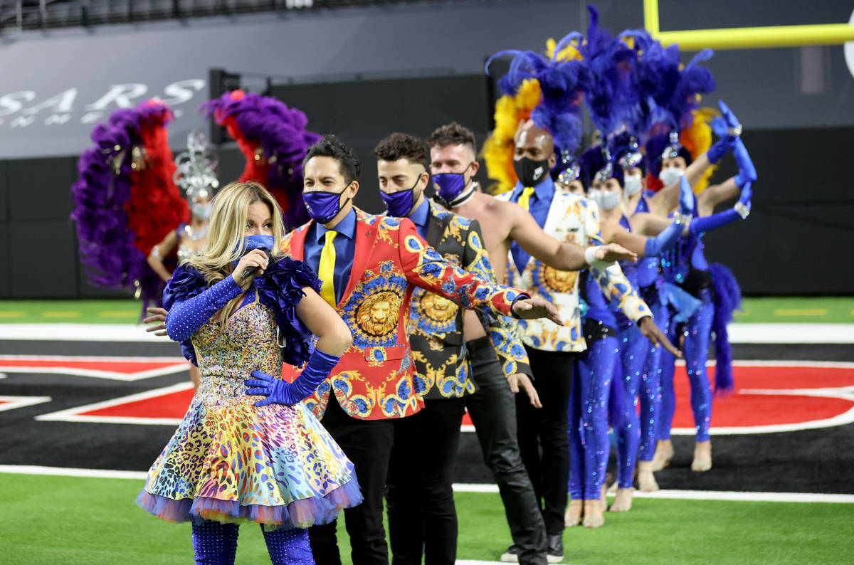 Las Vegas performers, including Lily Arce, left, put on a show at Allegiant Stadium as part of ...