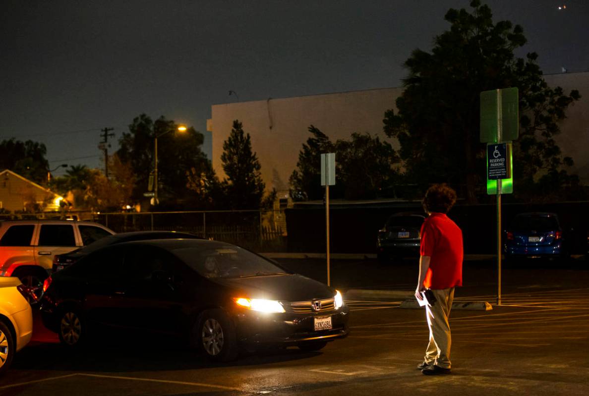 Adam Winteler waits to guide in the next car for the Horrorwood Video drive-in at the Majestic ...