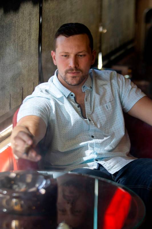 Comedian Rocky Dale Davis smokes a cigar at his regular hangout, En Fuego Cigars & Lounge in La ...