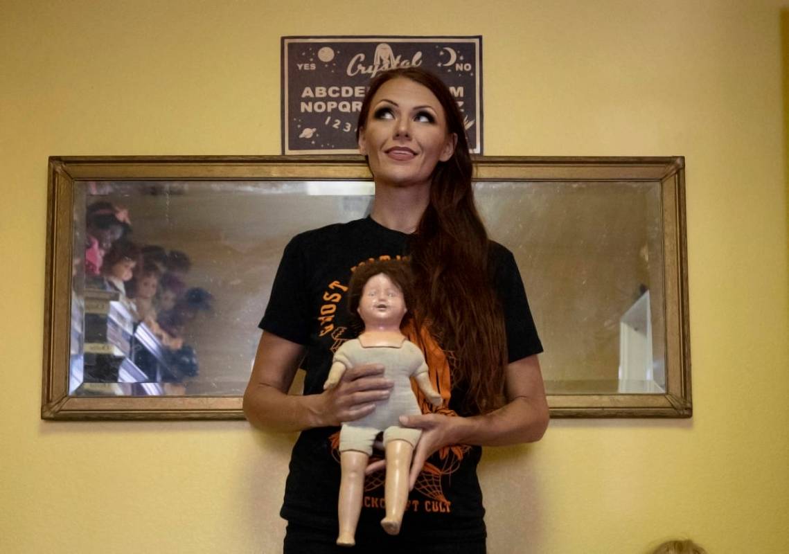 Paranormal enthusiast Staysha Randall is seen in front of a haunted mirror holding a doll with ...