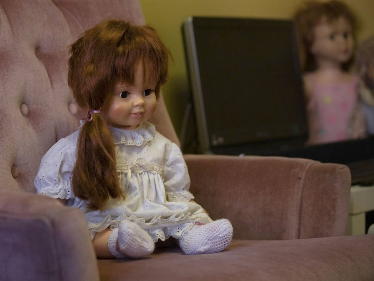 A doll that carries high activity, Katie, sits on a haunted chair in paranormal enthusiast Stay ...