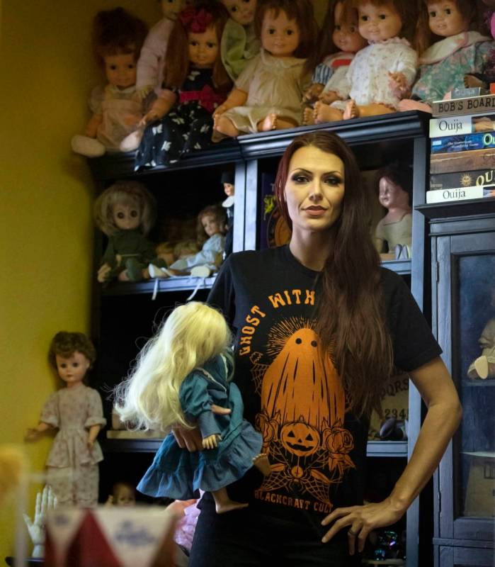 Paranormal enthusiast Staysha Randall is seen in front of a haunted mirror holding a doll with ...
