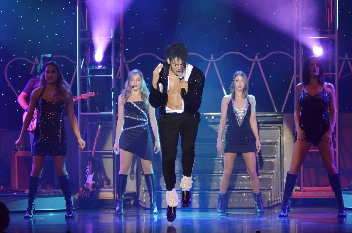 Jalles Franca, center, performs as Michael Jackson during "MJ Live" in the showroom at the Stra ...