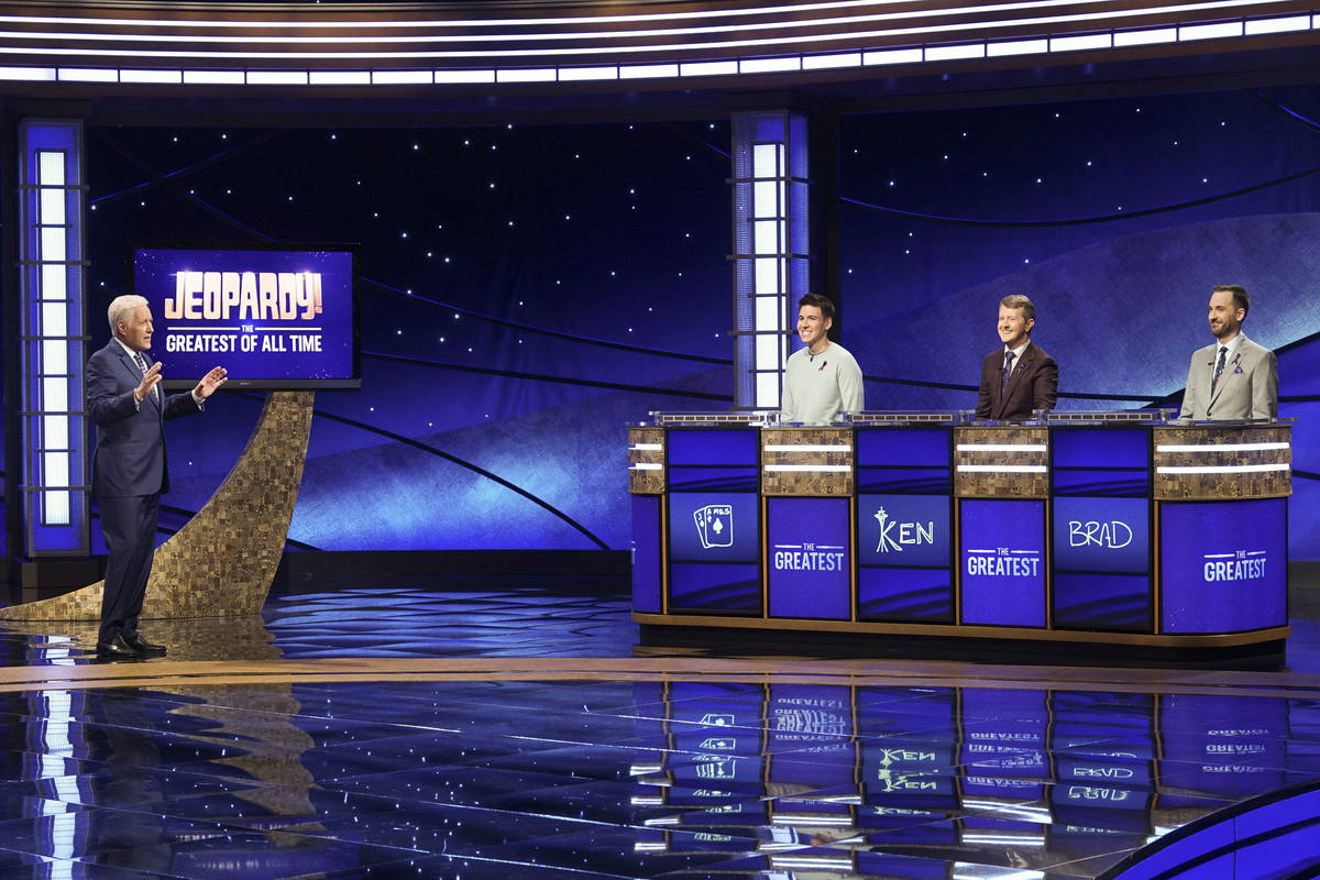 In this image released by ABC, host Alex Trebec, left, appear with contestants, James Holzhauer ...