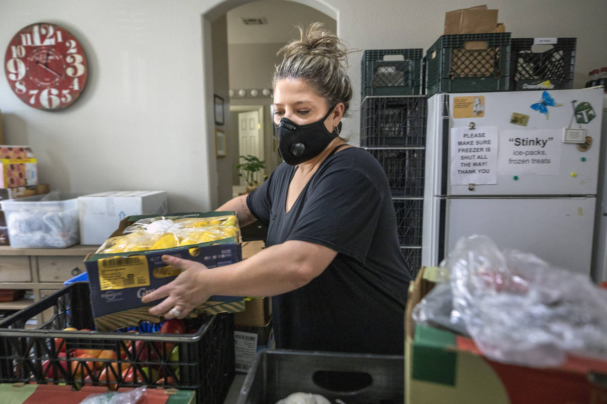 Katinka Fresinski, founder of 24Meals, packs meals created by local chefs to be distributed to ...
