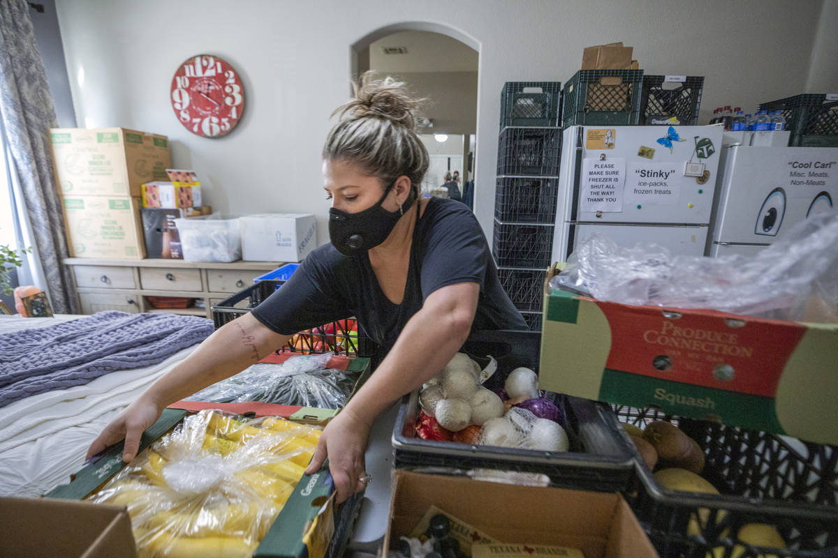 Katinka Fresinski, founder of 24Meals, organizes the pantry located in the spare bedroom of her ...
