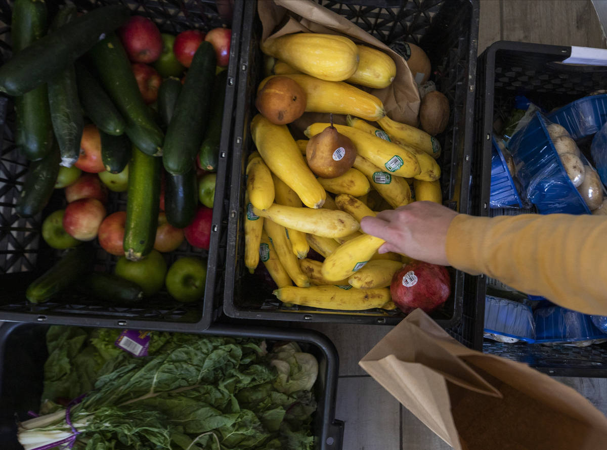24Meals volunteer Sarah Wittstock, 34, of Las Vegas, packs donated produce to be paired with me ...