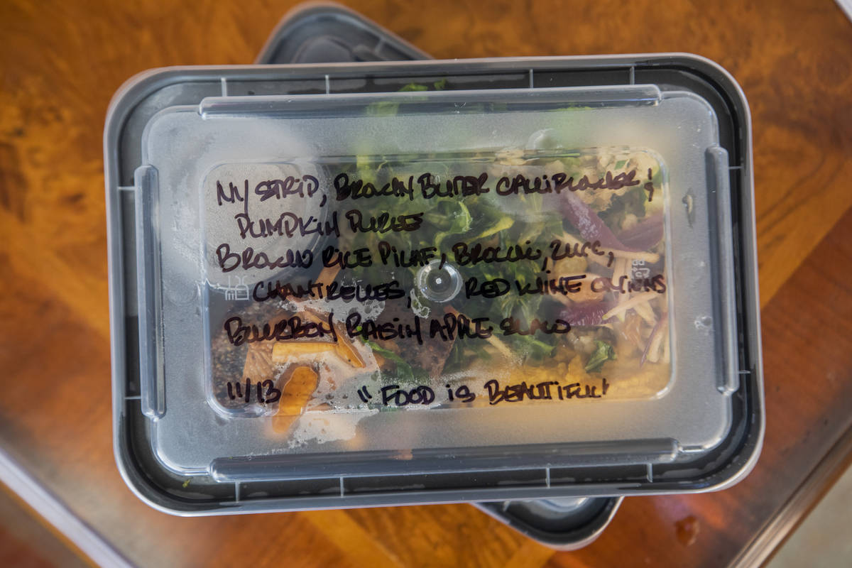Katinka Fresinski, founder of 24Meals, packs meals created by local chefs to be distributed to ...