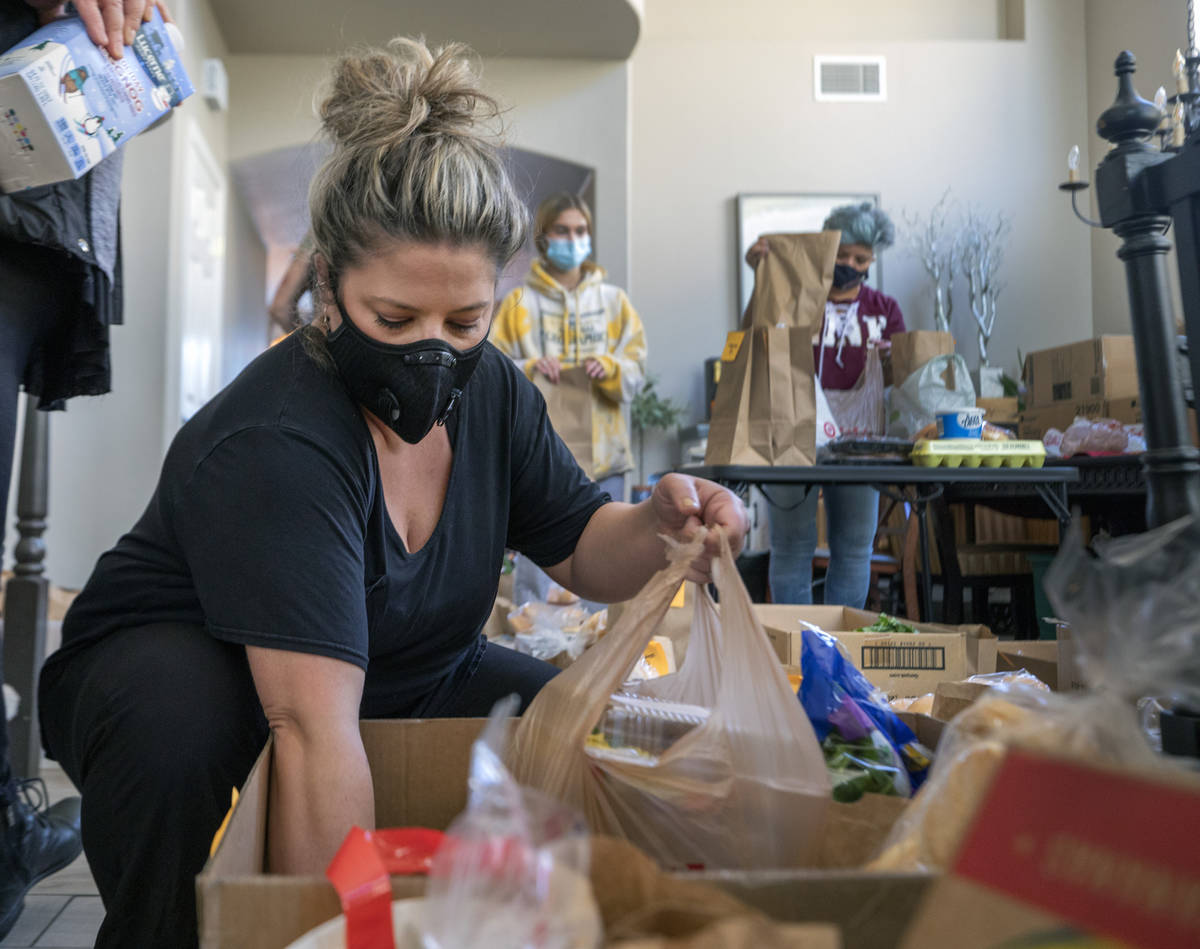 Katinka Fresinski, founder of 24Meals, packs meals created by local chefs to be distributed to ...