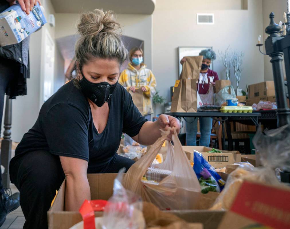 Katinka Fresinski, founder of 24Meals, packs meals created by local chefs to be distributed to ...