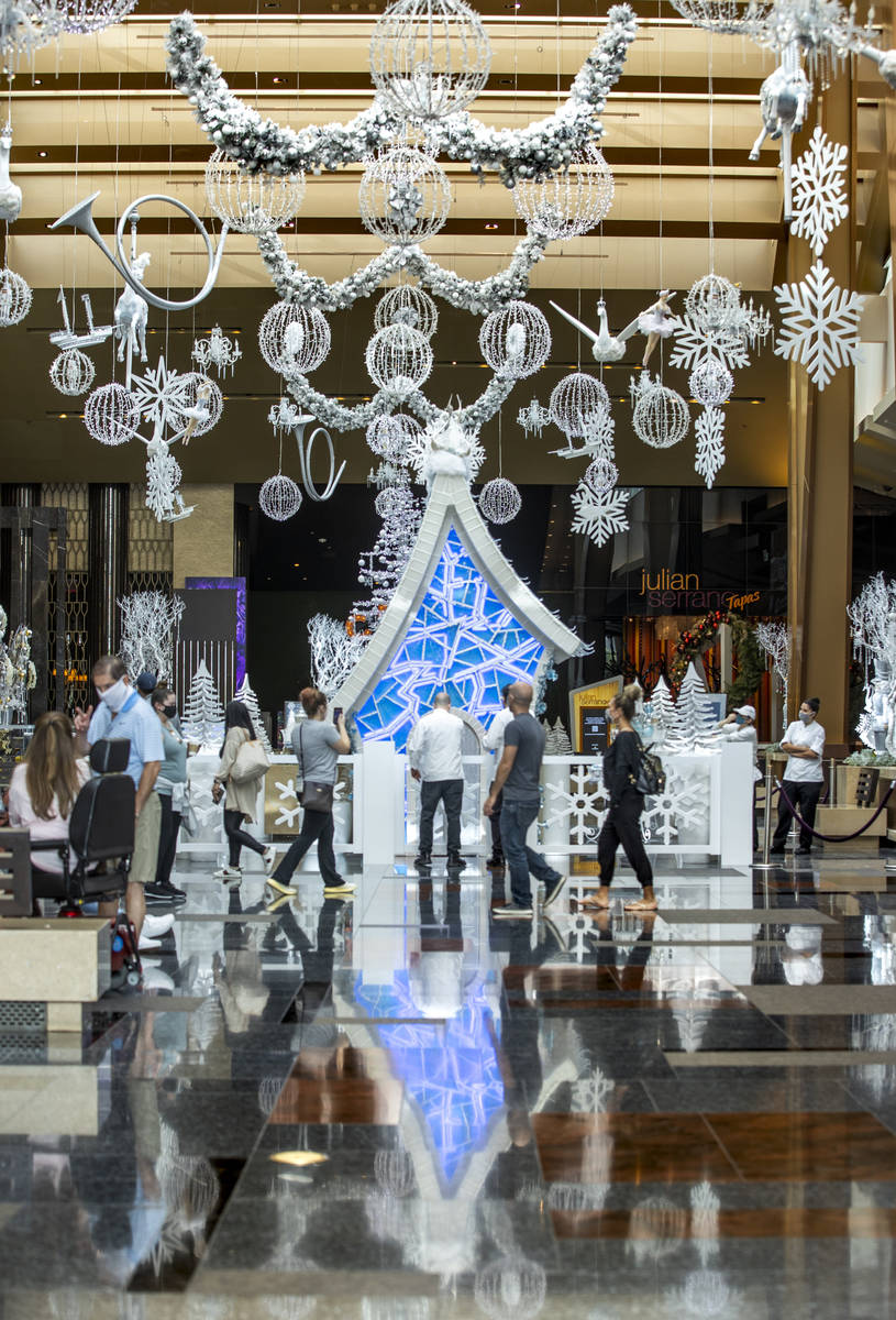 Lighting and decorations hang from the ceiling as part of Aria's unveiling of the holiday lobby ...