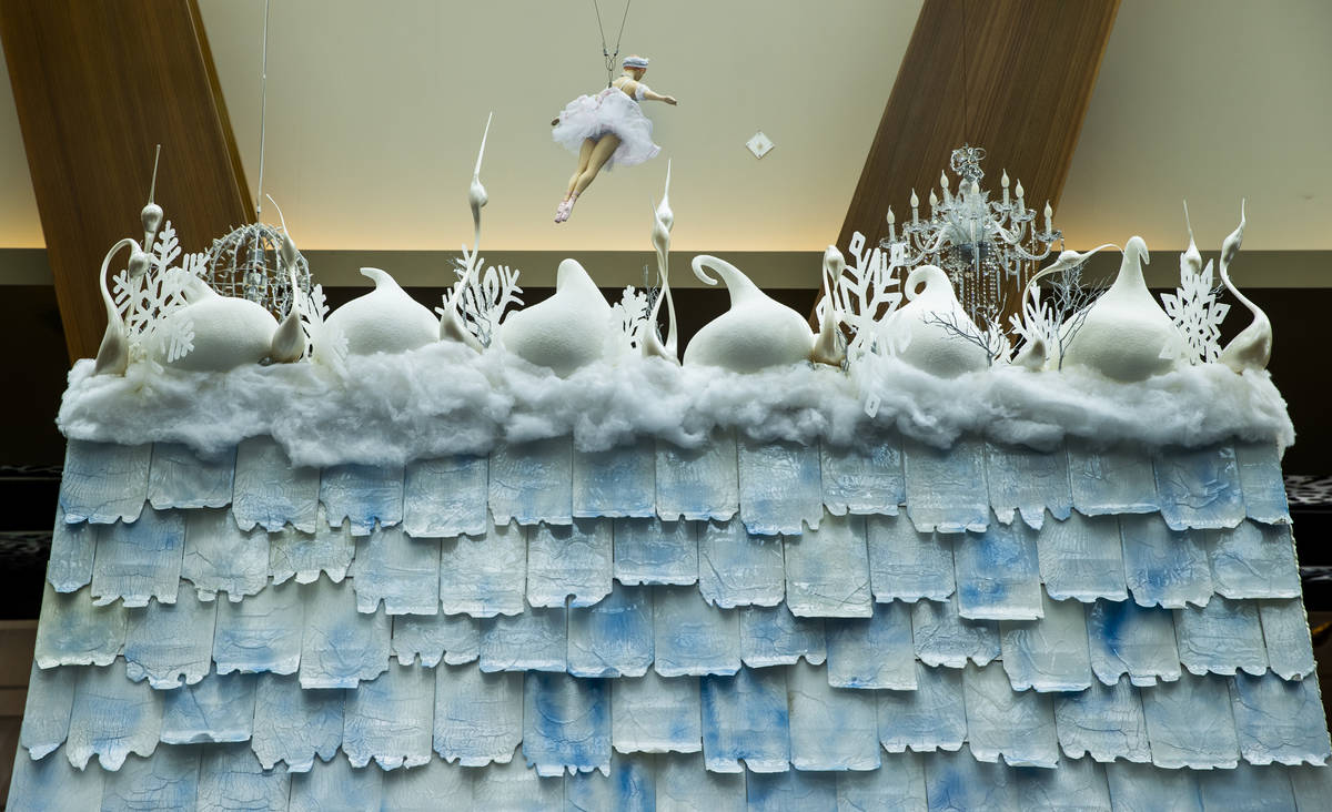 Seven various sugar techniques are employed including sugar swans atop the roof at Aria's holid ...