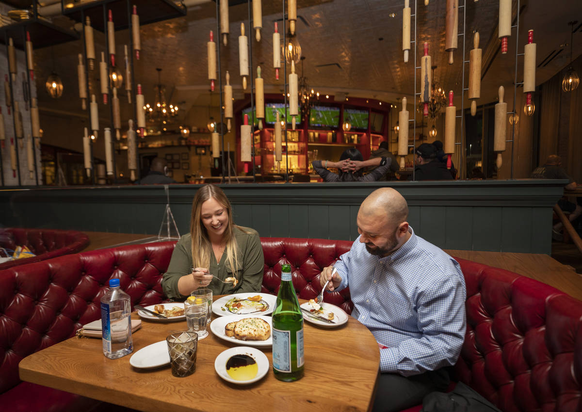 Tourists from Orange County Lauren McLane, 27, left, and John Paton, 28, dine at Buddy V's Rist ...