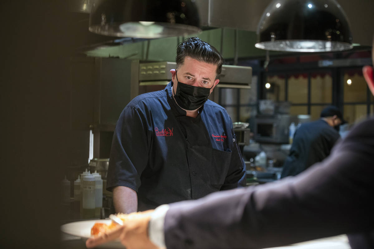 Executive sous chef Christian Gonzalez oversees dishes going out to be served at Buddy V's Rist ...