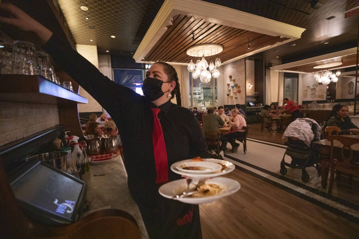 Server Kacie Calimeri works the night before Gov. Steve Sisolak's "statewide pause" mandate goe ...