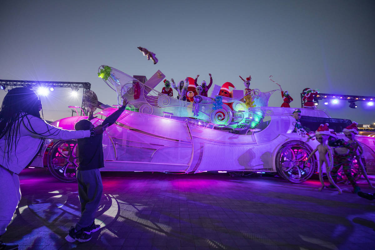 Toys are thrown to kids from a sleigh during the kick off of "Wanderland" holiday experience at ...
