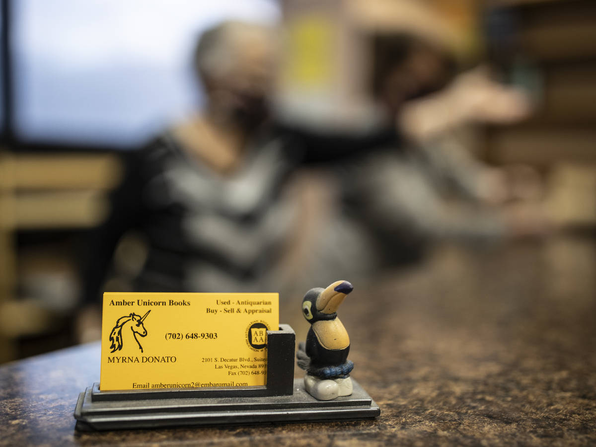 Myrna DonatoÕs card sits on the front desk of Amber Unicorn Books, while the storeÕs ...