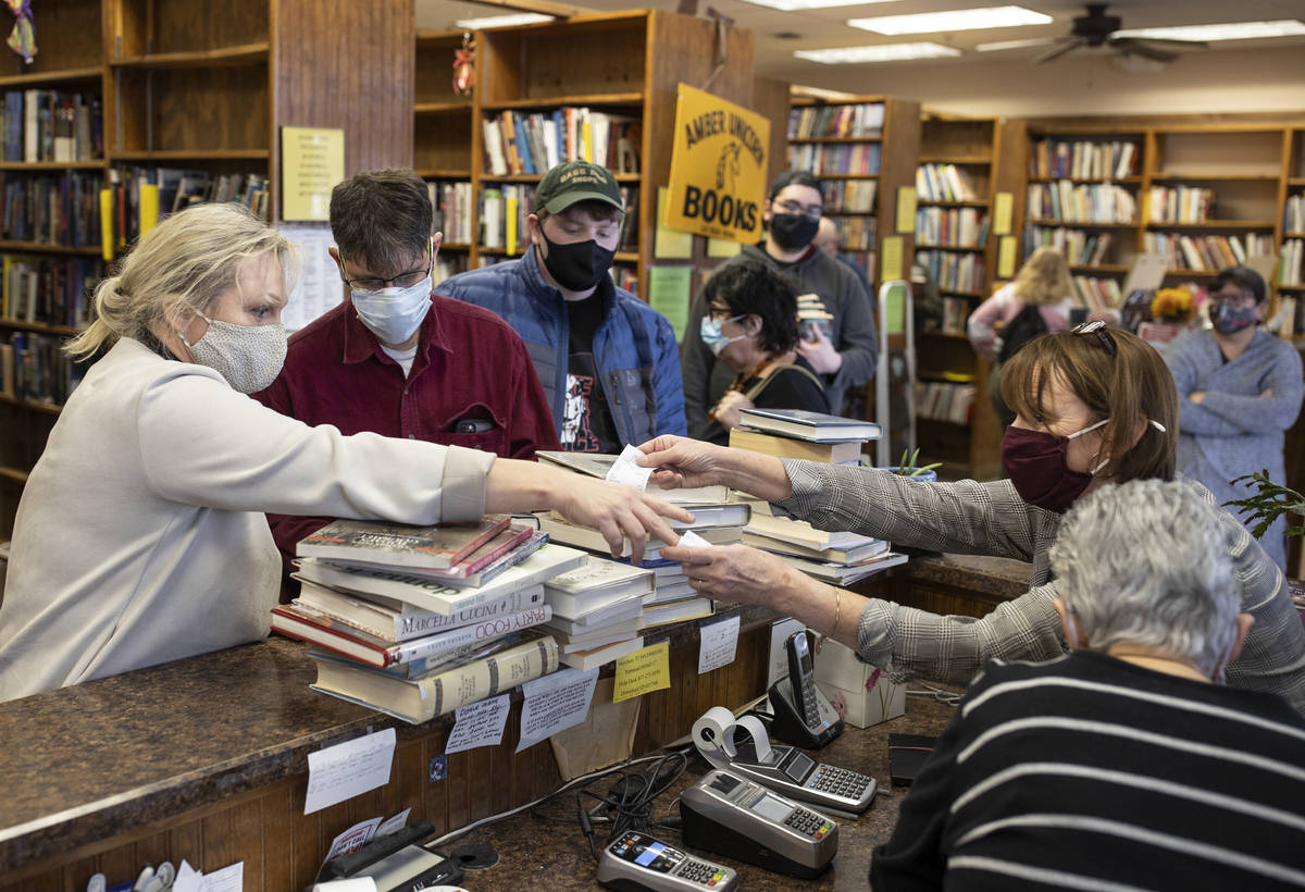 Customers flood the front desk at Amber Unicorn Books on the last business day of the Vegas lan ...