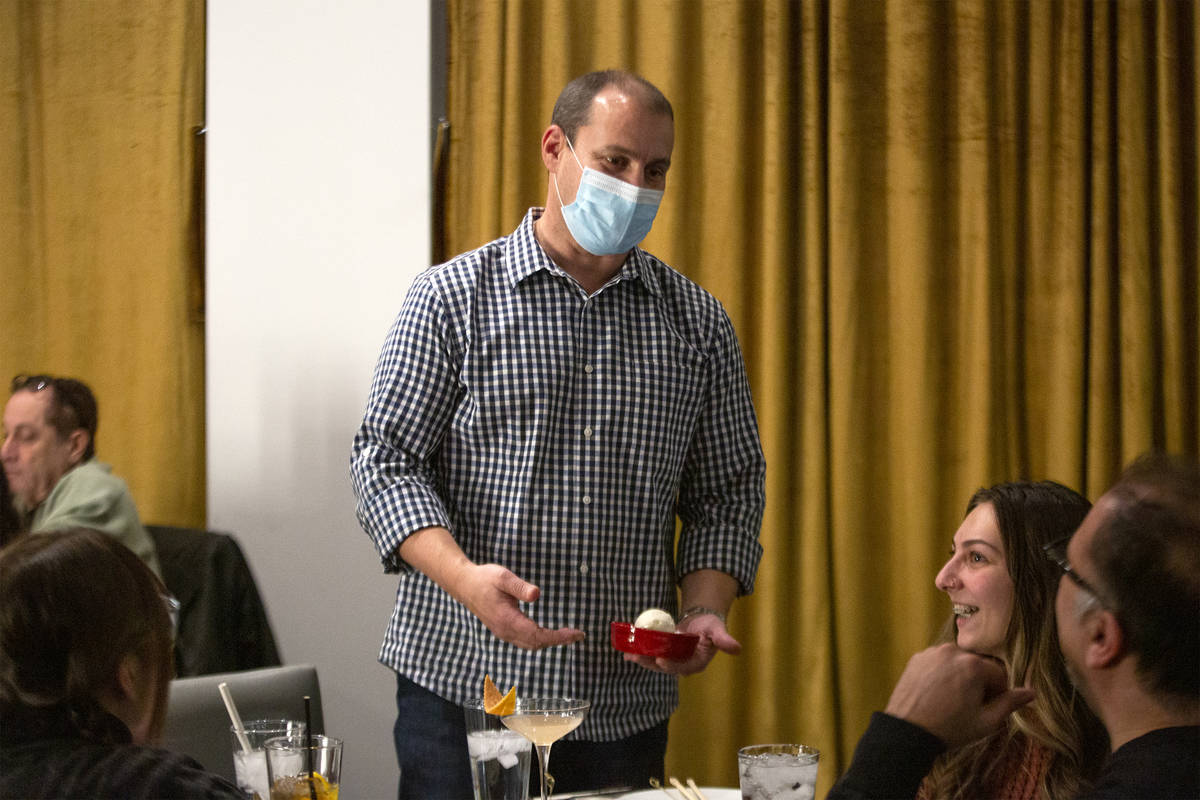 Co-owner of Chinglish Cantonese Wine Bar Ken Heck delivers a dessert to a group of diners on Th ...