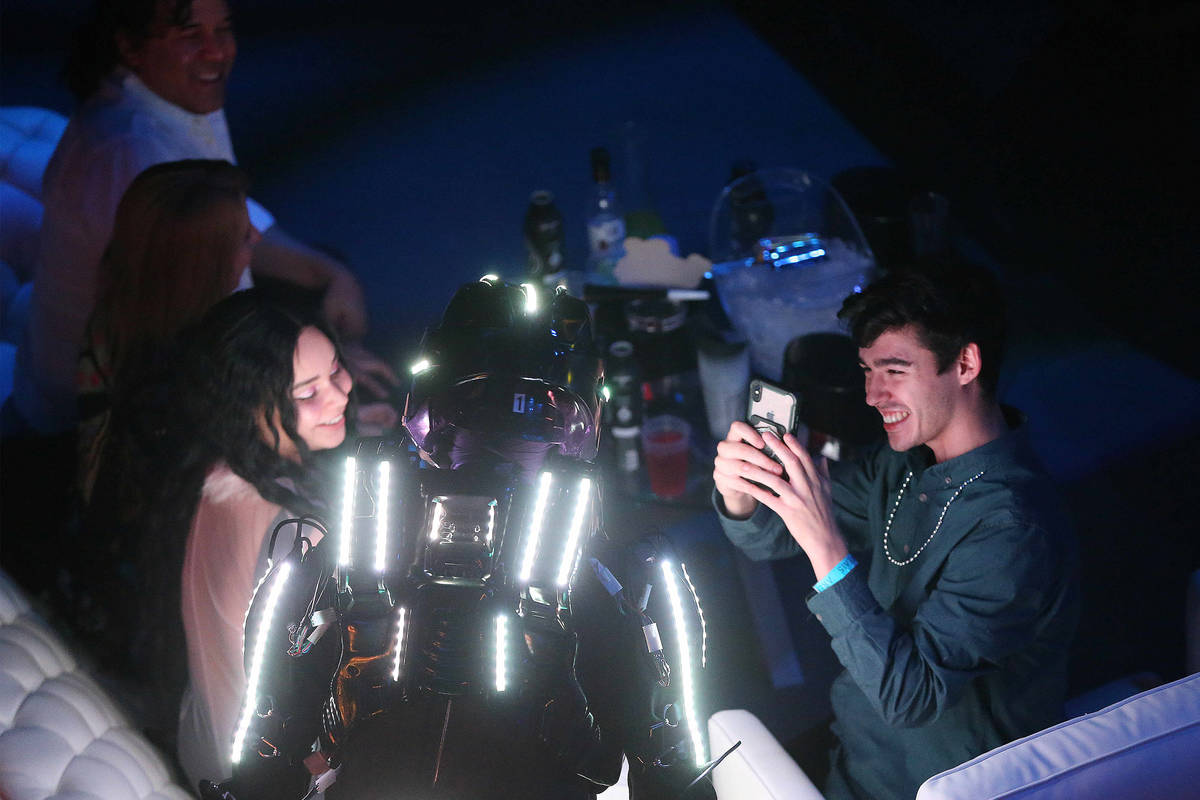 A performer engages attendees during the "Illuminate" New Year’s Eve celebration at Area15 in ...
