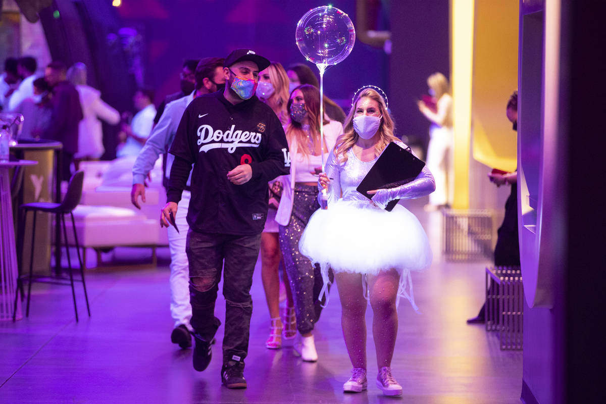 People attend the "Illuminate" New Year’s Eve celebration at Area15 in Las Vegas on Thursday, ...
