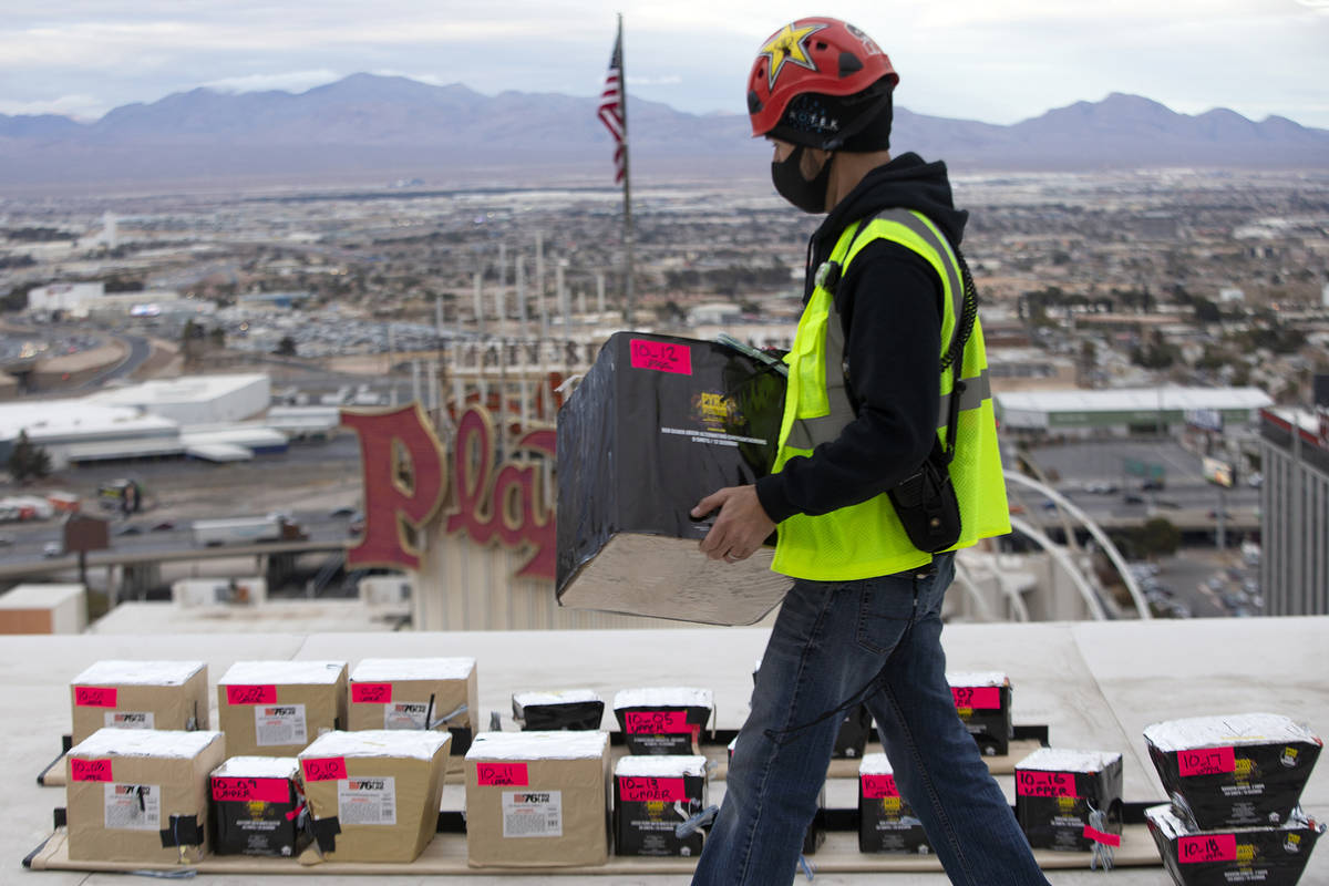 Pyrotechnician Nate Tanner strategically places fireworks on top of the Plaza ahead of the New ...