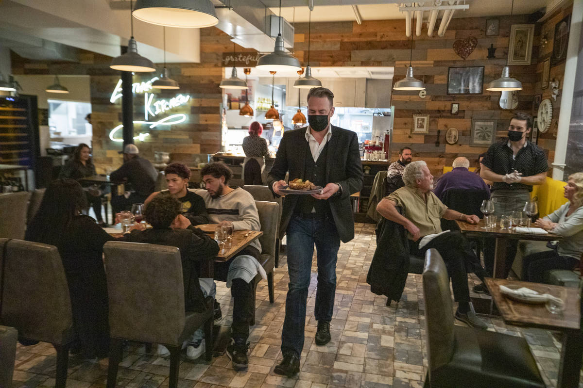 Individuals dine at EstherÕs Kitchen in downtown Las Vegas on Thursday, Dec. 31, 2020. (El ...
