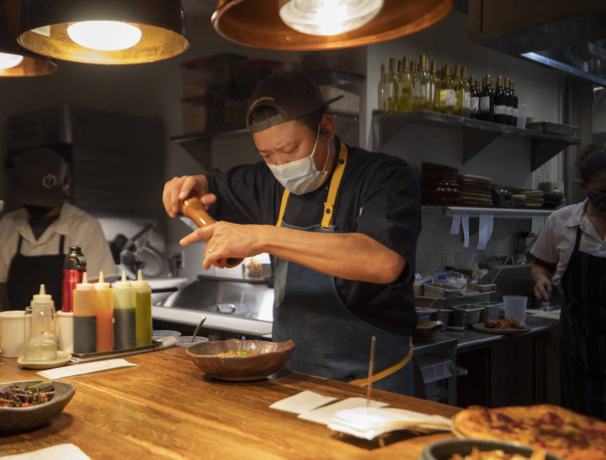 Chef Stephen Lee puts finishing touches on a course at EstherÕs Kitchen in downtown Las Ve ...