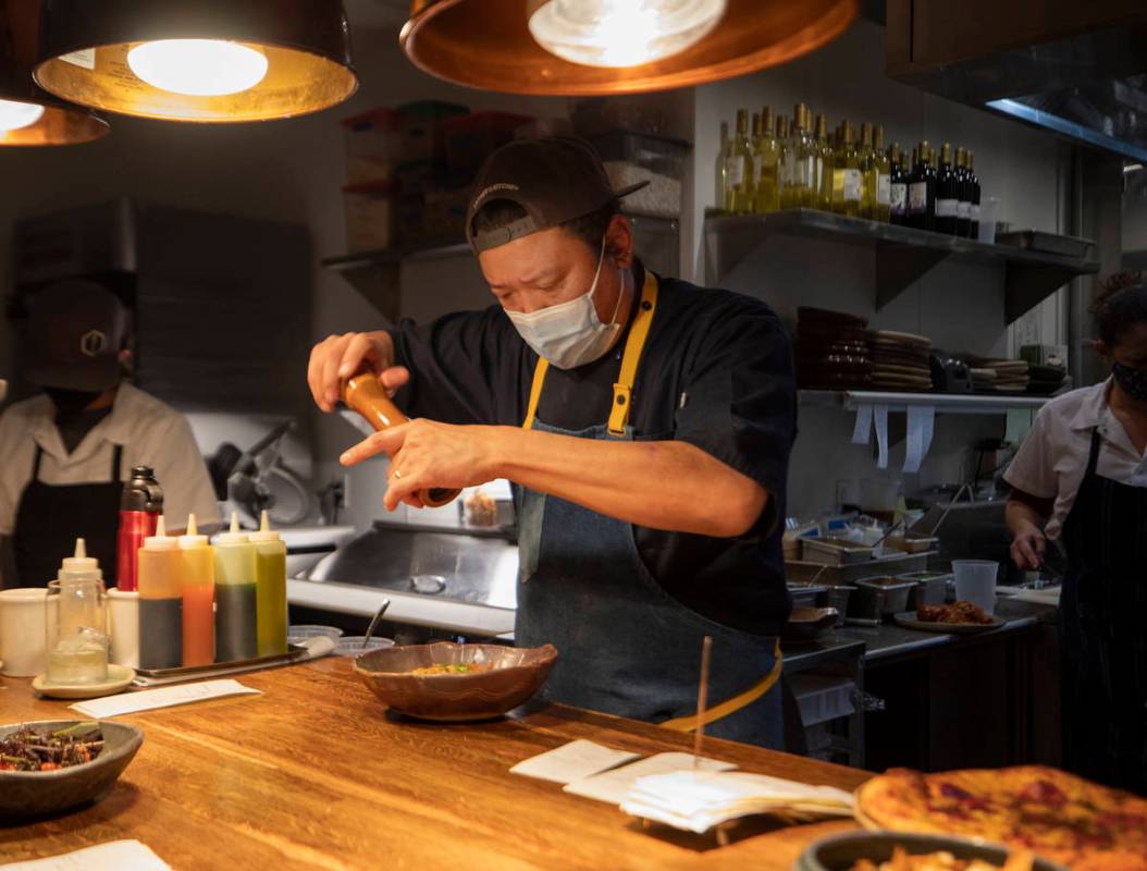 Chef Stephen Lee puts finishing touches on a course at EstherÕs Kitchen in downtown Las Ve ...
