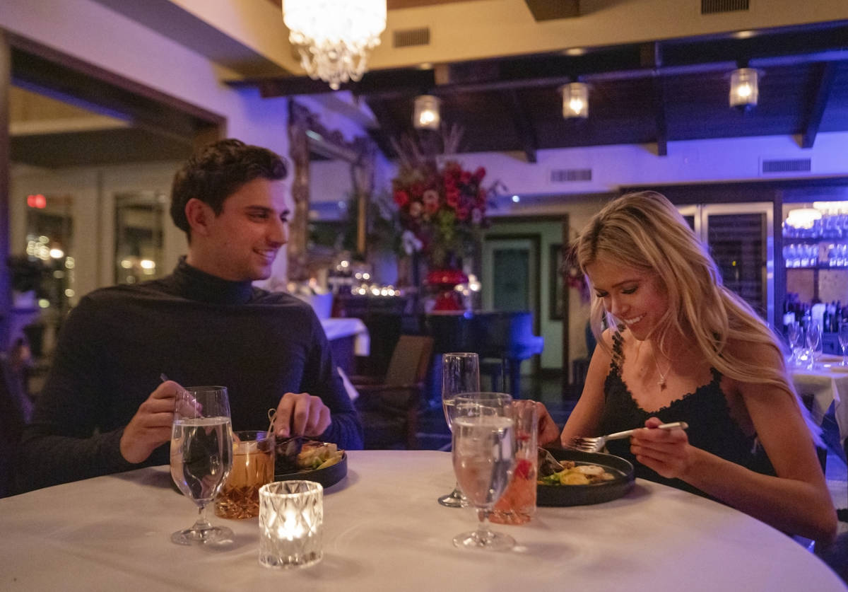Jesse Neely, 23, of Las Vegas, left, and Taylor DeRose, 23, of North Las Vegas, dine at America ...