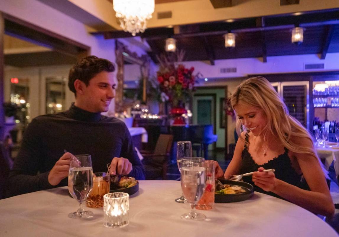 Jesse Neely, 23, of Las Vegas, left, and Taylor DeRose, 23, of North Las Vegas, dine at America ...