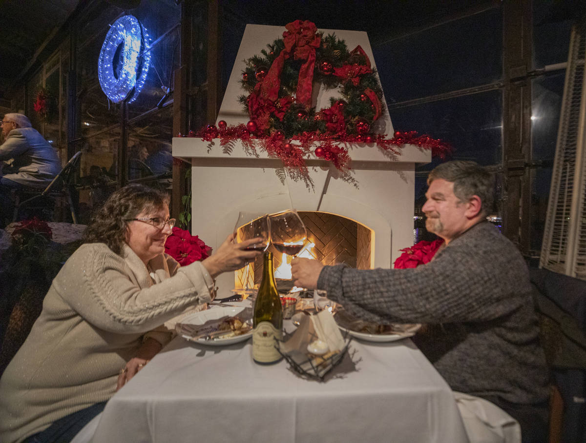 Caryn and Eric Shallita of Las Vegas cheers during their last meal of 2020, at Marche Bacchus i ...