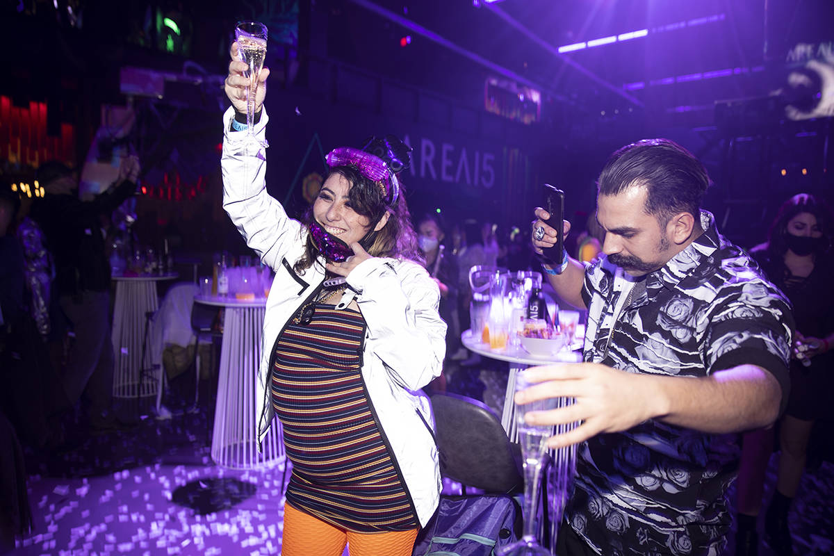 people participate in the Illuminate New Year’s Eve celebration at Area 15 in Las Vegas, ...