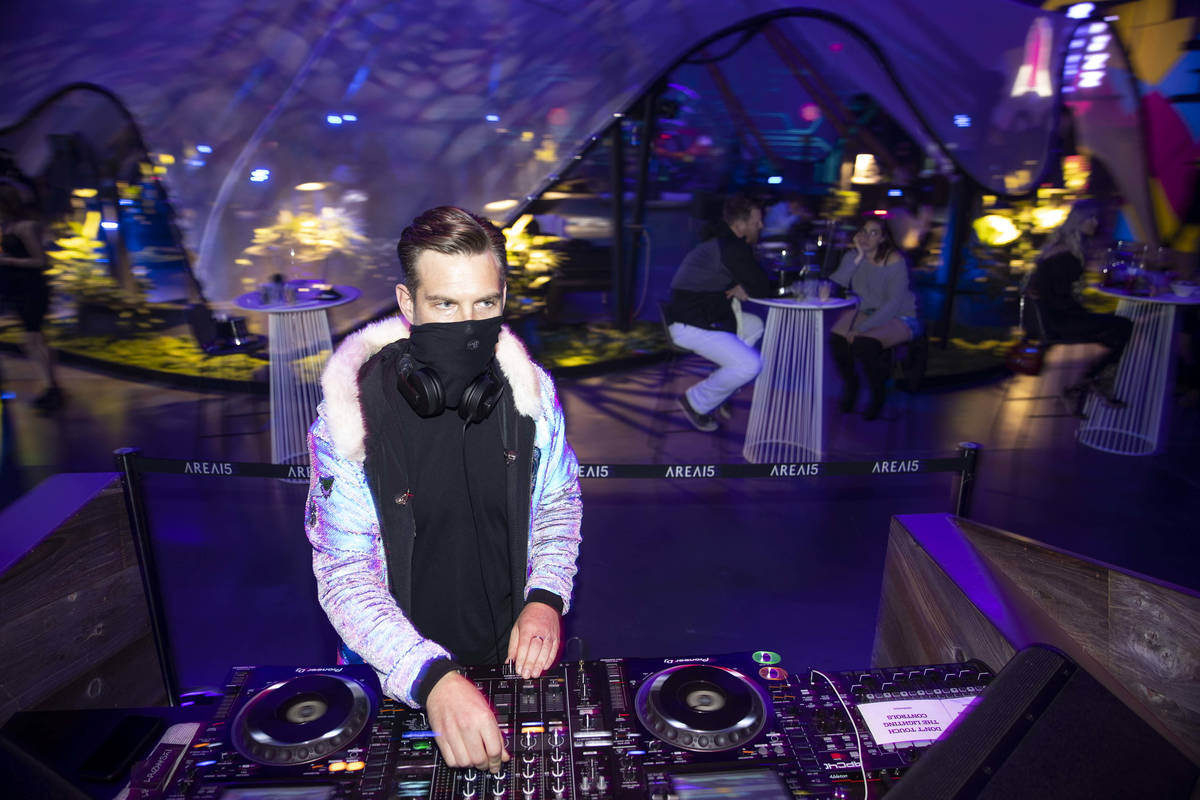 A DJ performs during the Illuminate New Year’s Eve celebration at Area 15 in Las Vegas, ...
