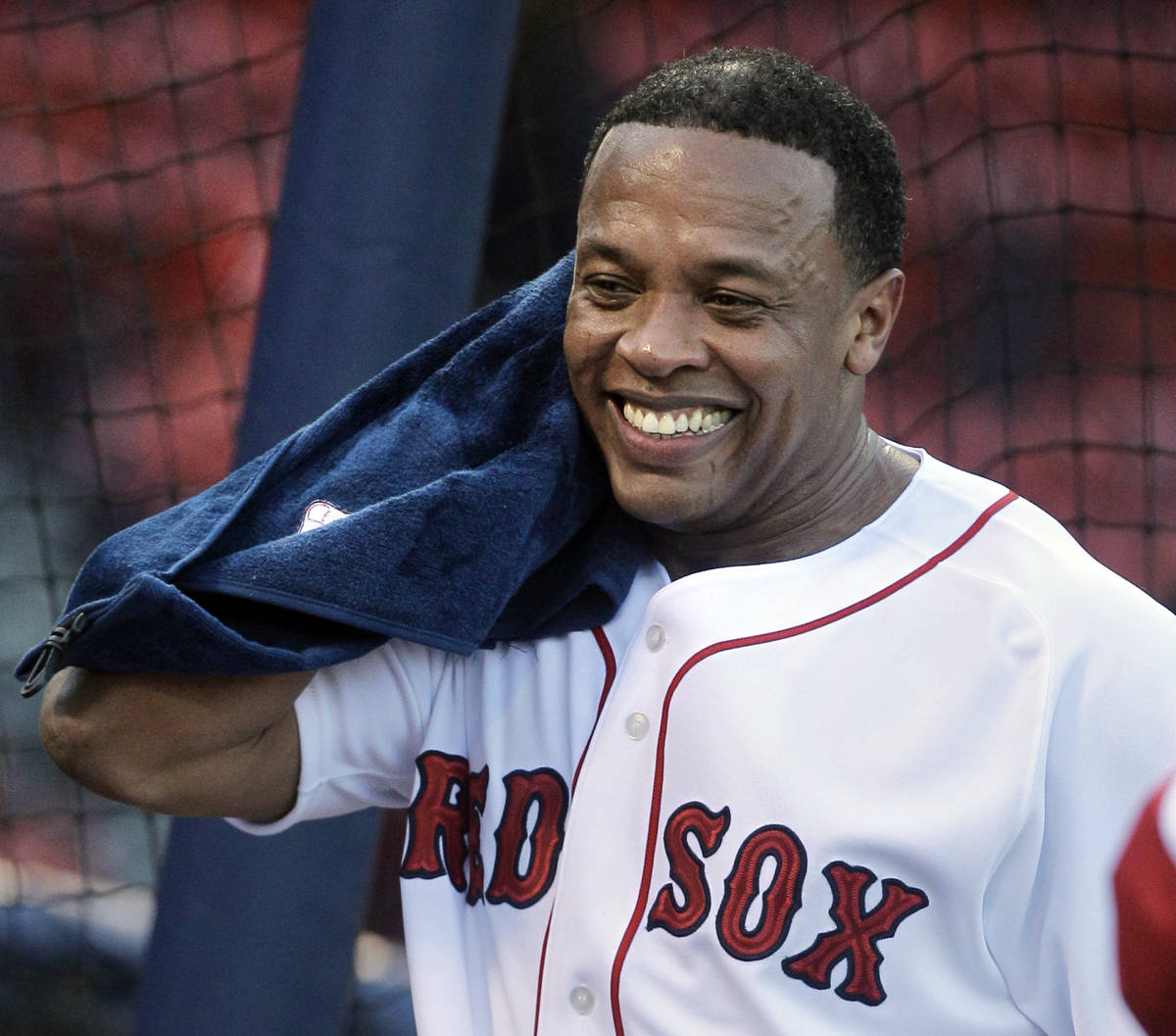 Rapper and producer Dr. Dre towels off after taking batting practice at Fenway Park before the ...